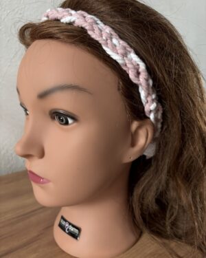 Uniek gevlochten roze met wit haarlint.